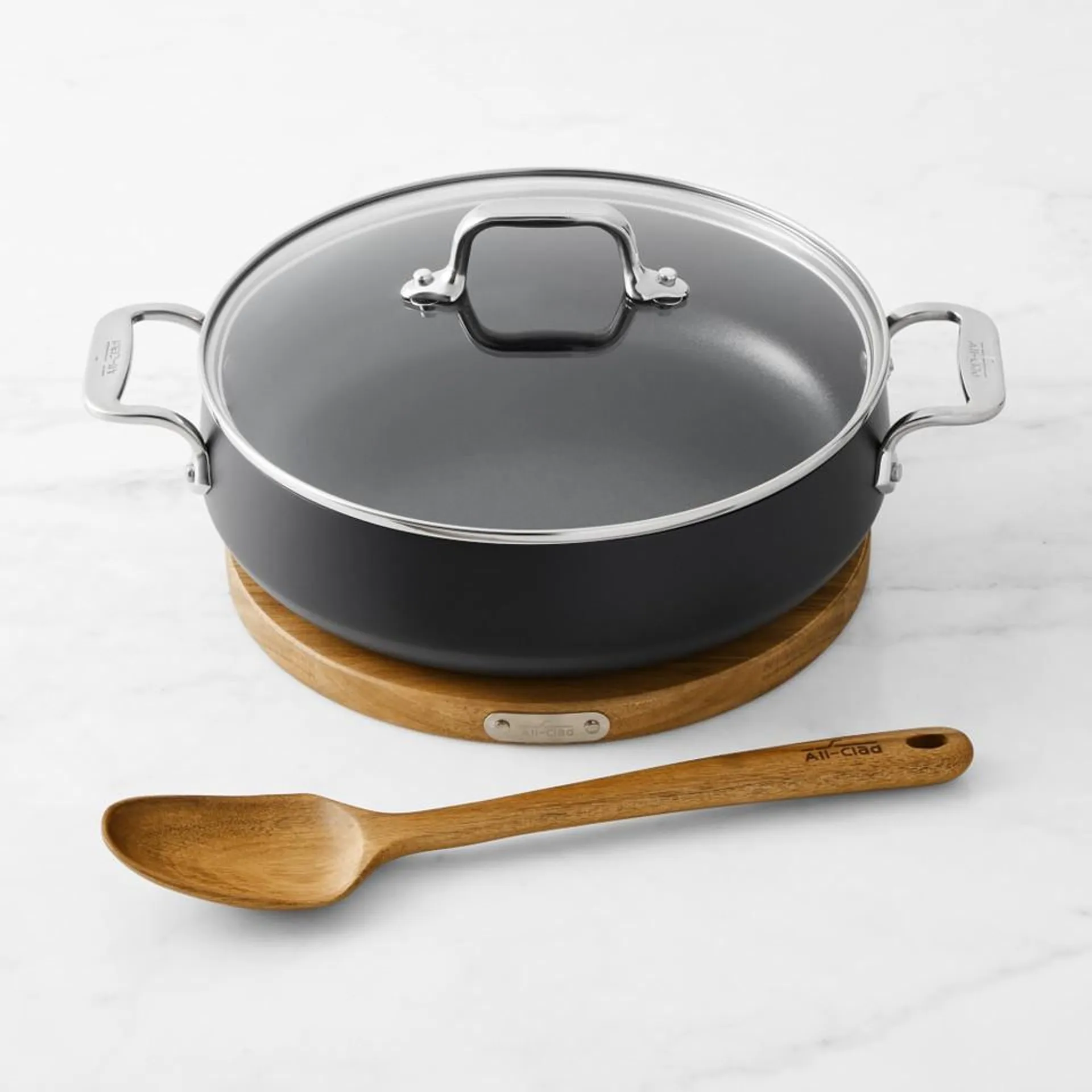 All-Clad HA1 Hard Anodised Non-Stick Sauteuse with Wooden Trivet & Spoon