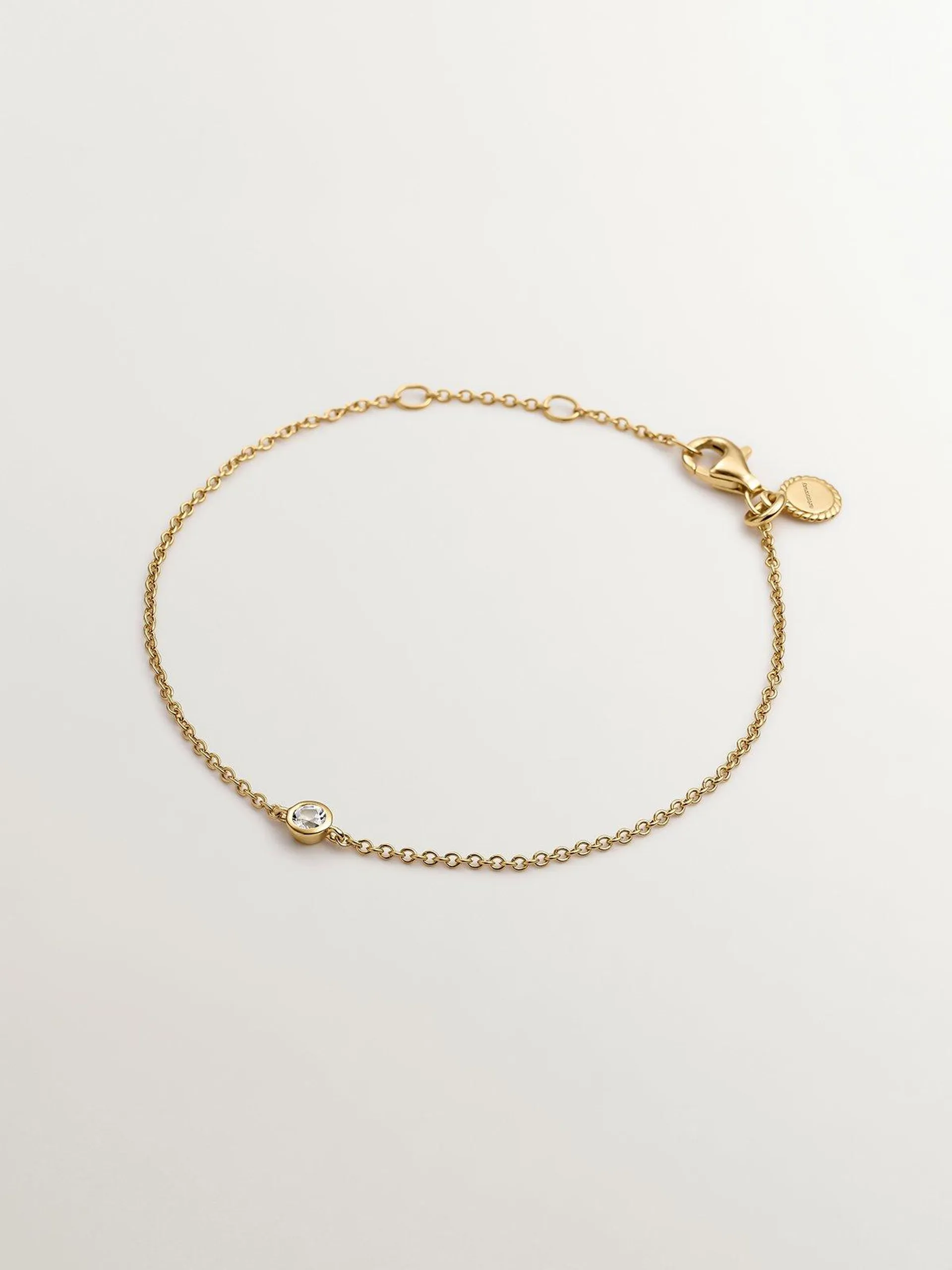 Pulsera solitario de plata 925 bañada en oro amarillo de 18K con topacio blanco