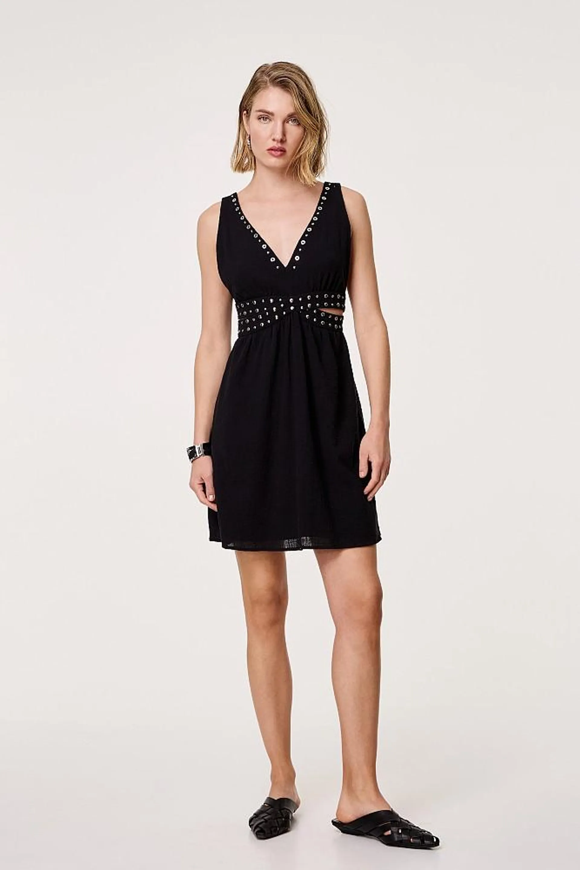 Dress with studs and cut out