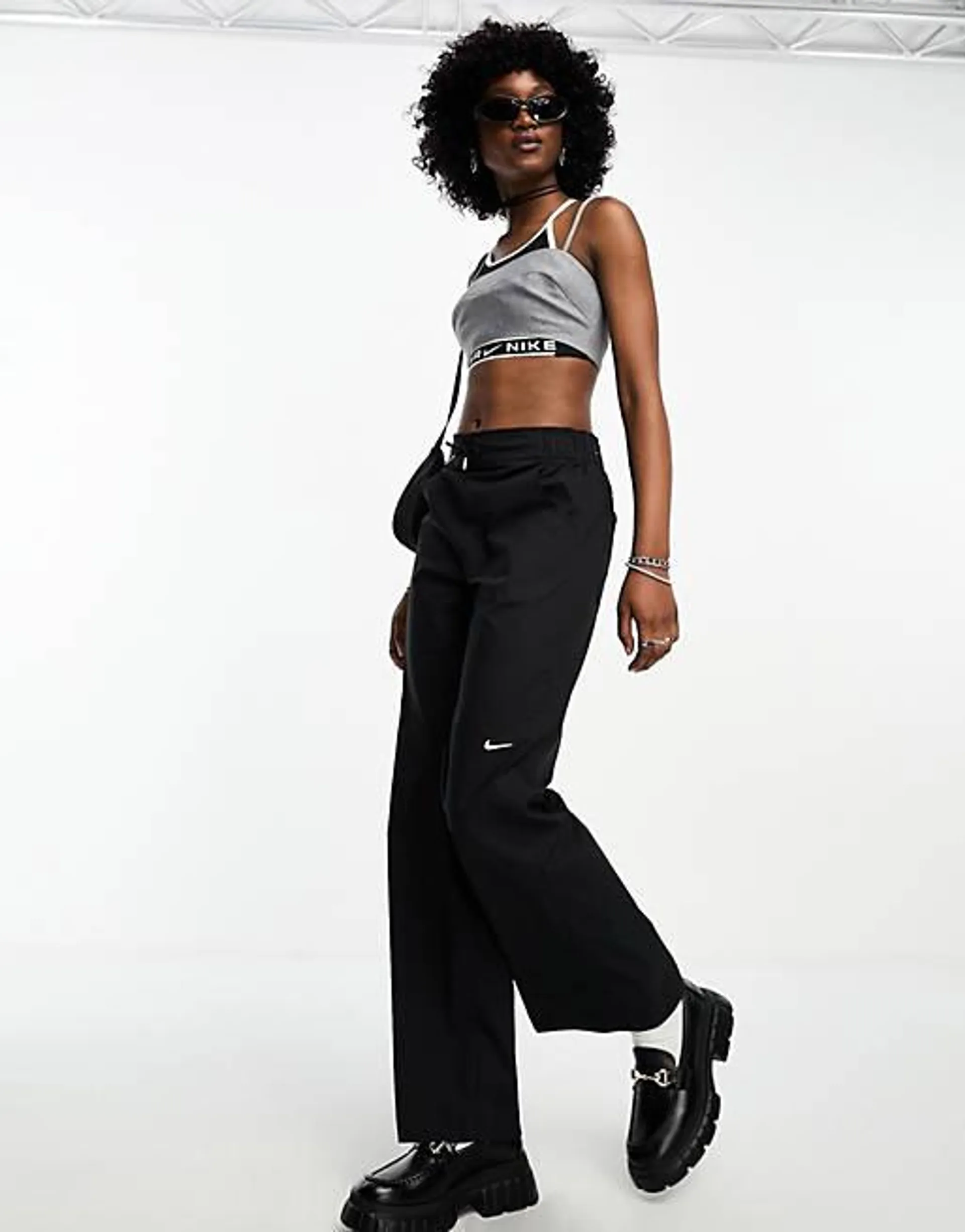 Nike mini swoosh high rise woven trousers in black