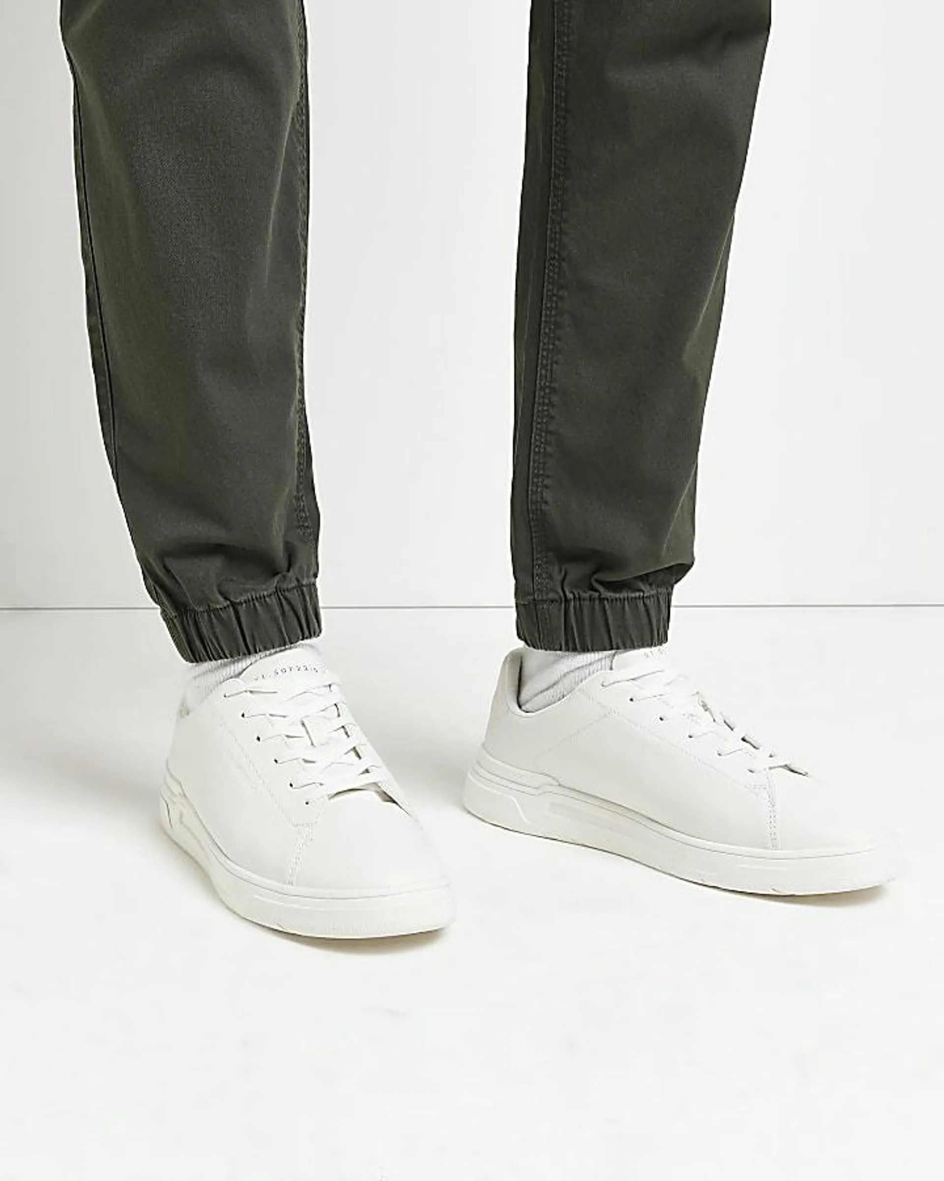 White lace up cupsole trainers