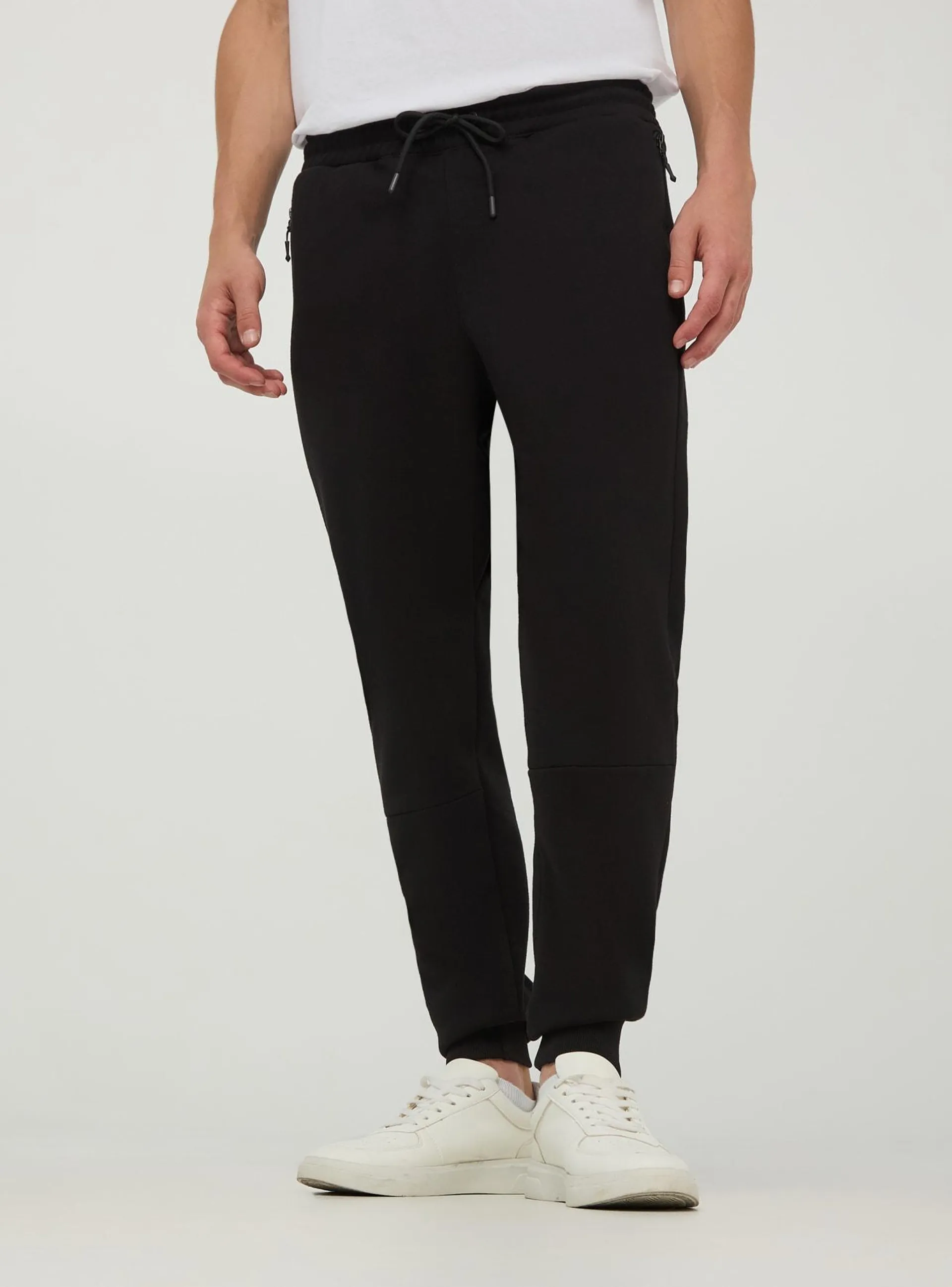 Pantaloni tuta tessuto tecnico con tasche con zip Nero