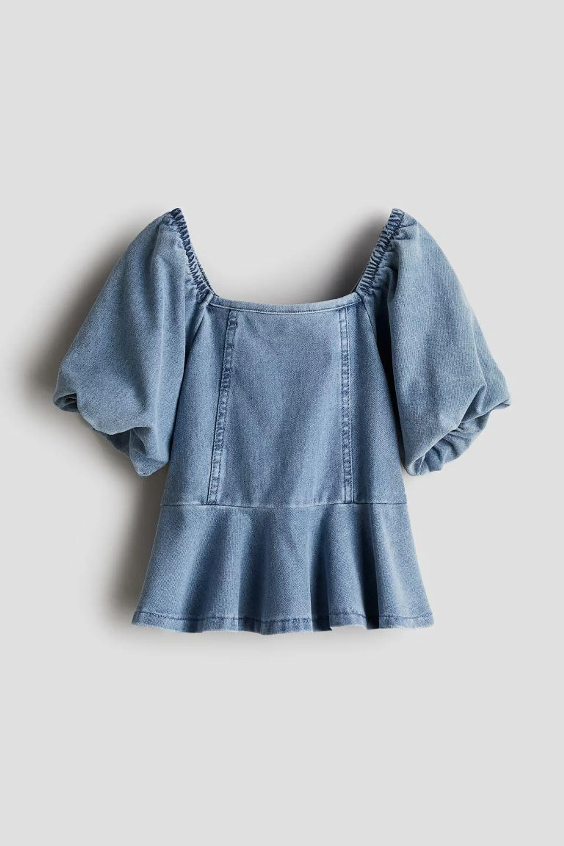 Blusa con peplum apariencia denim