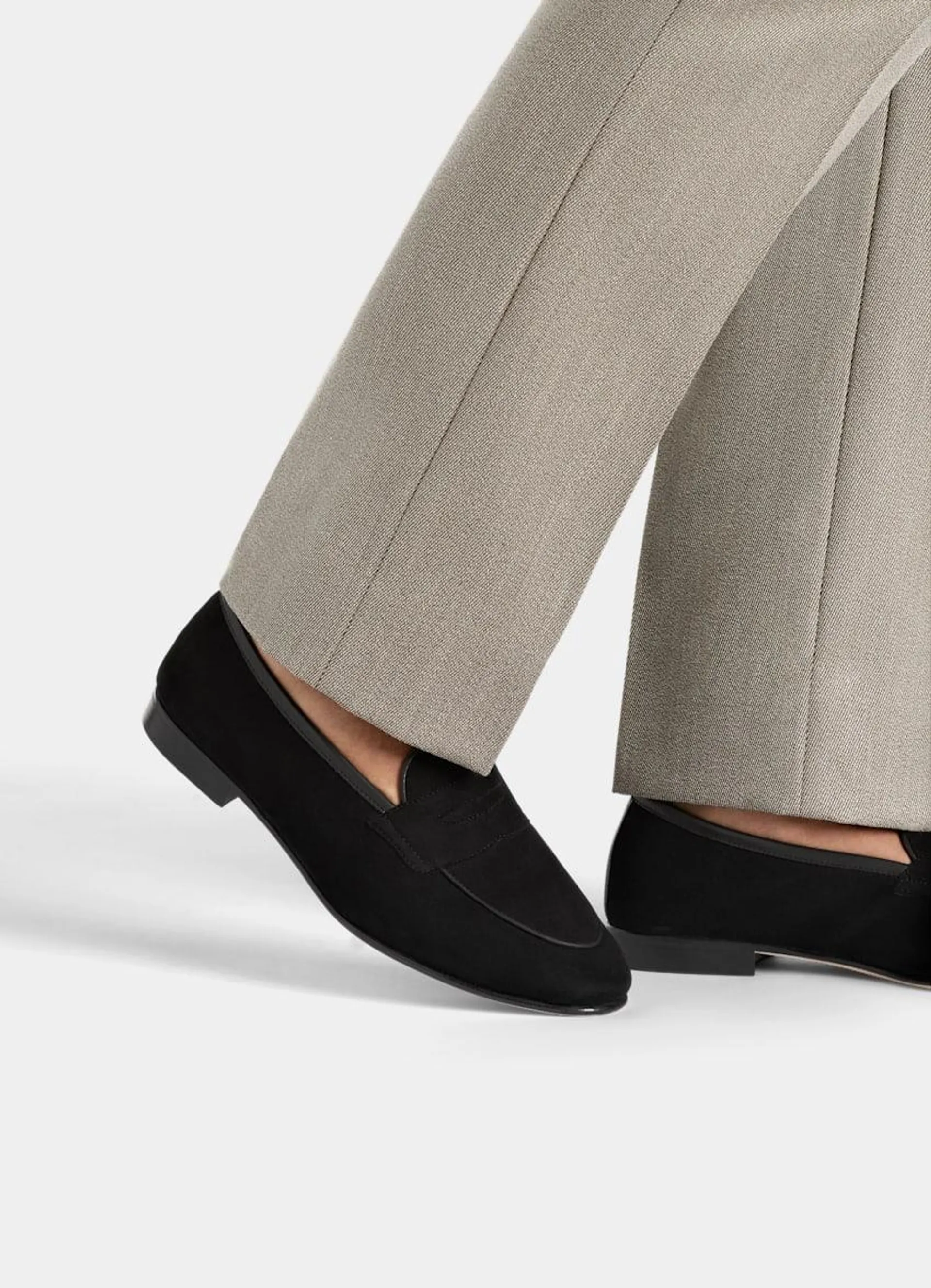 These sleek black penny loafers are crafted in Portugal from Italian calf suede, and feature a durable leather sole and a refined cemented construction for lasting style.