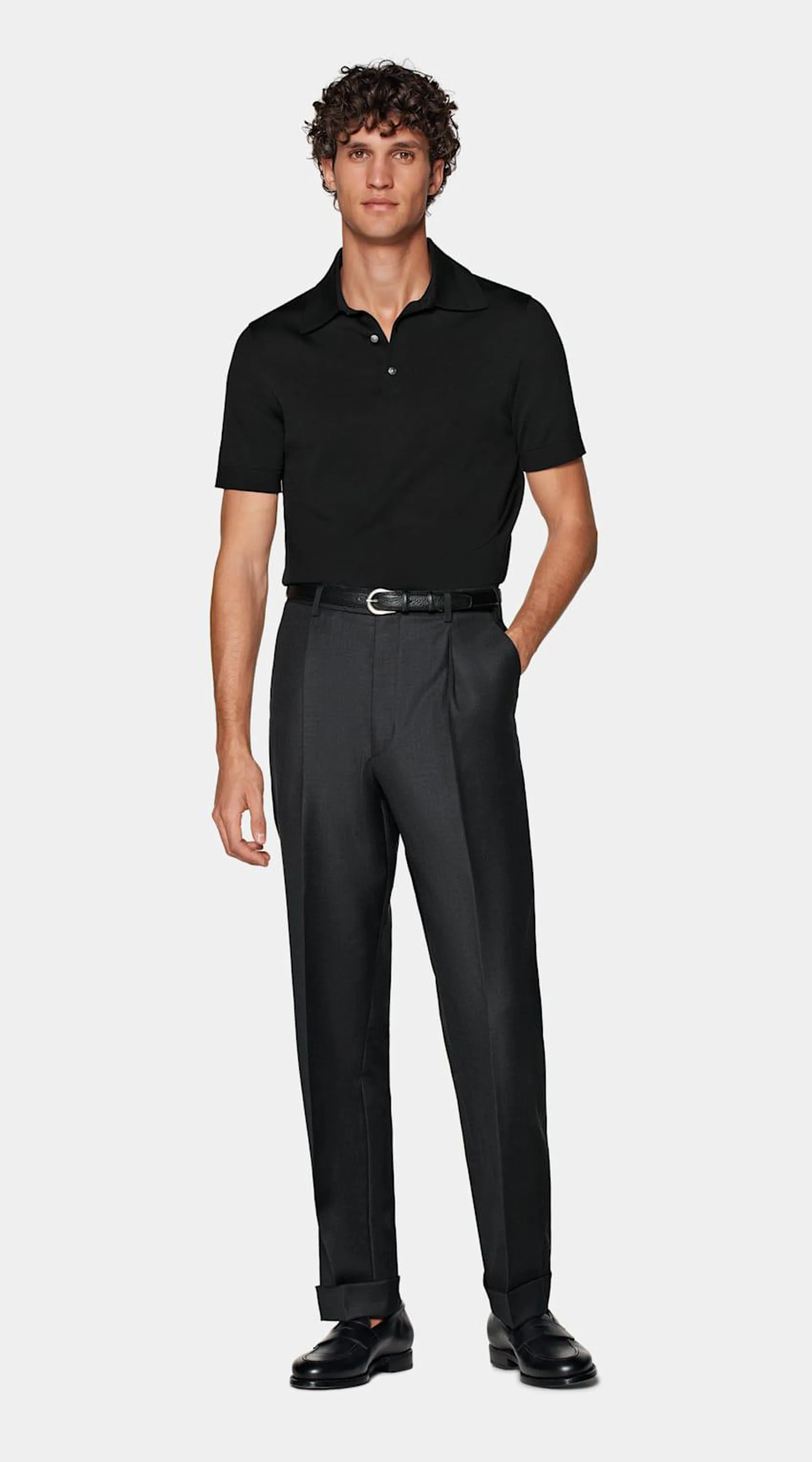 Boasting a soft collar, lustrous mother of pearl buttons, and ribbed detailing, this black slim fit polo is tailored for a comfortable yet elevated look.