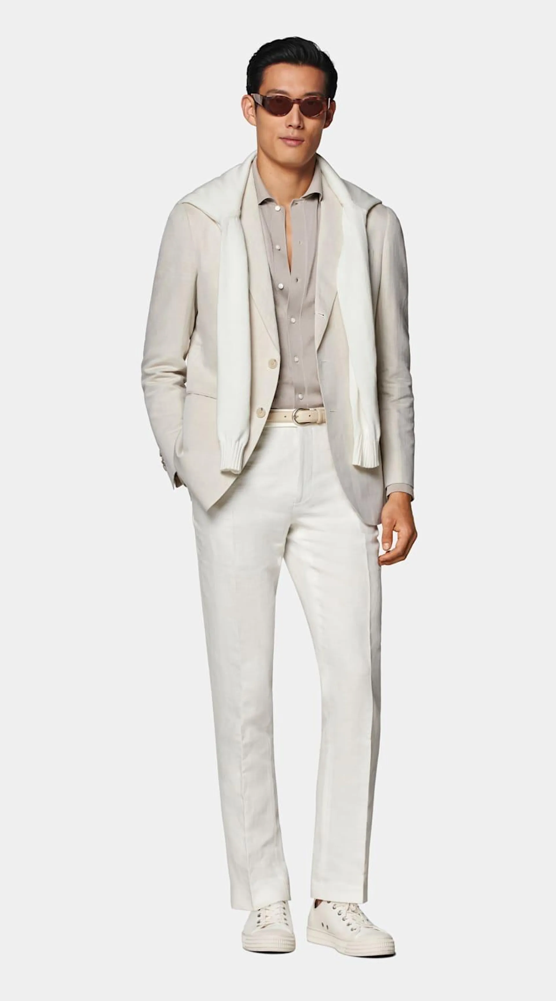 This sand-colored blazer is cut to a tailored fit and features a natural unpadded shoulder.