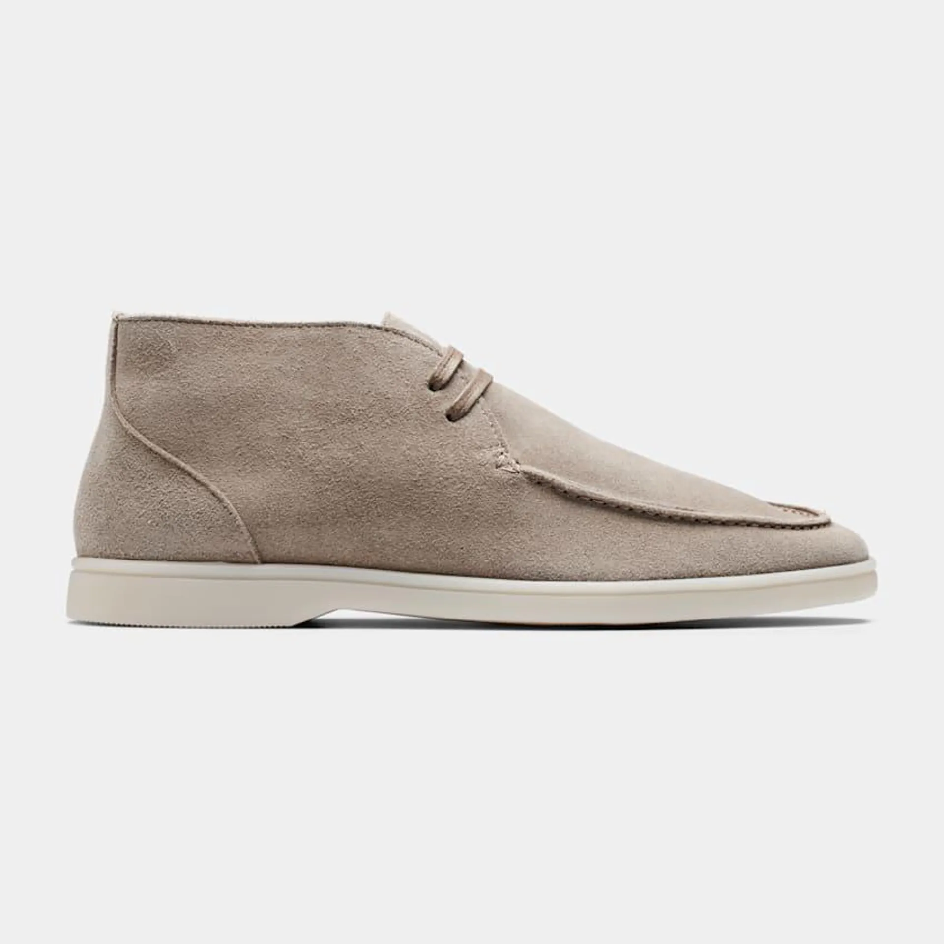 Seamlessly adapting between relaxed and elevated casual styles, these sand chukka boots are crafted in Portugal from double-faced suede with an apron toe and rubber sole.