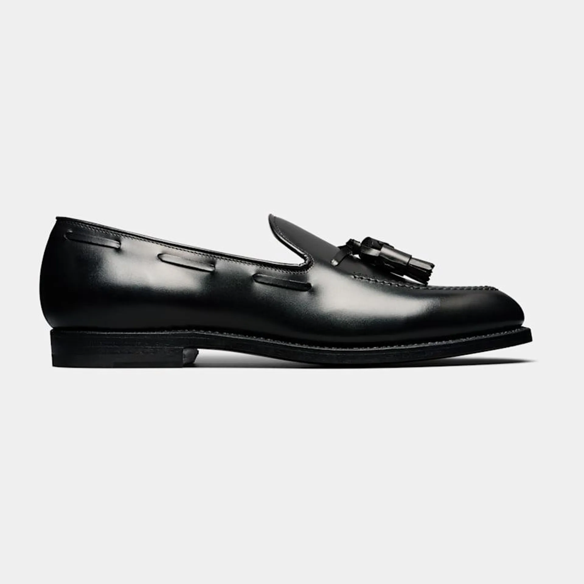 These polished black tassel loafers, meticulously crafted in Italy from fine Italian calf leather, feature a sleek leather sole and are crafted in durable Goodyear construction.