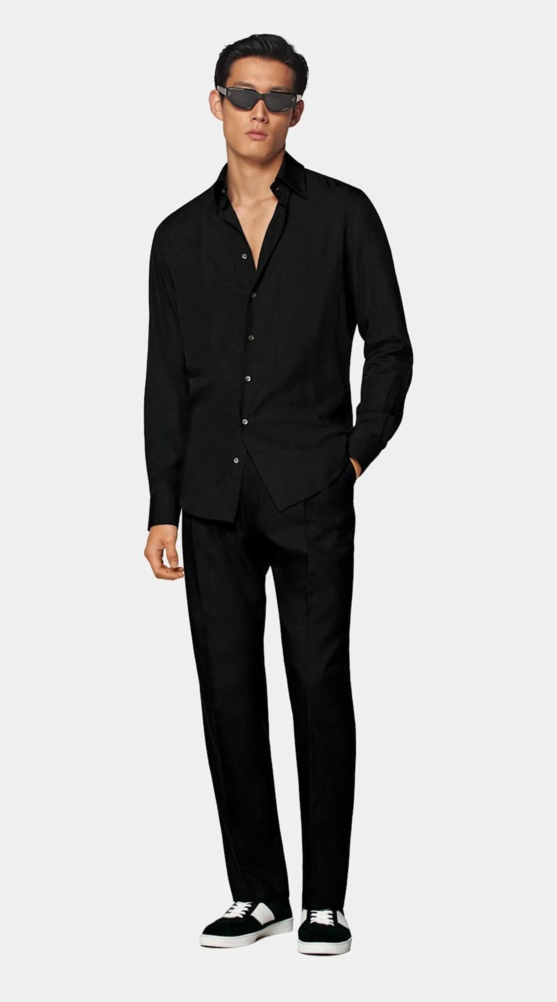 On its own or paired with a jacket, this adaptable black shirt is tailored slim with large point collar, ultra-fine stitching, a neat french placket, and a subtly curved hemline that's perfect for wearing untucked.