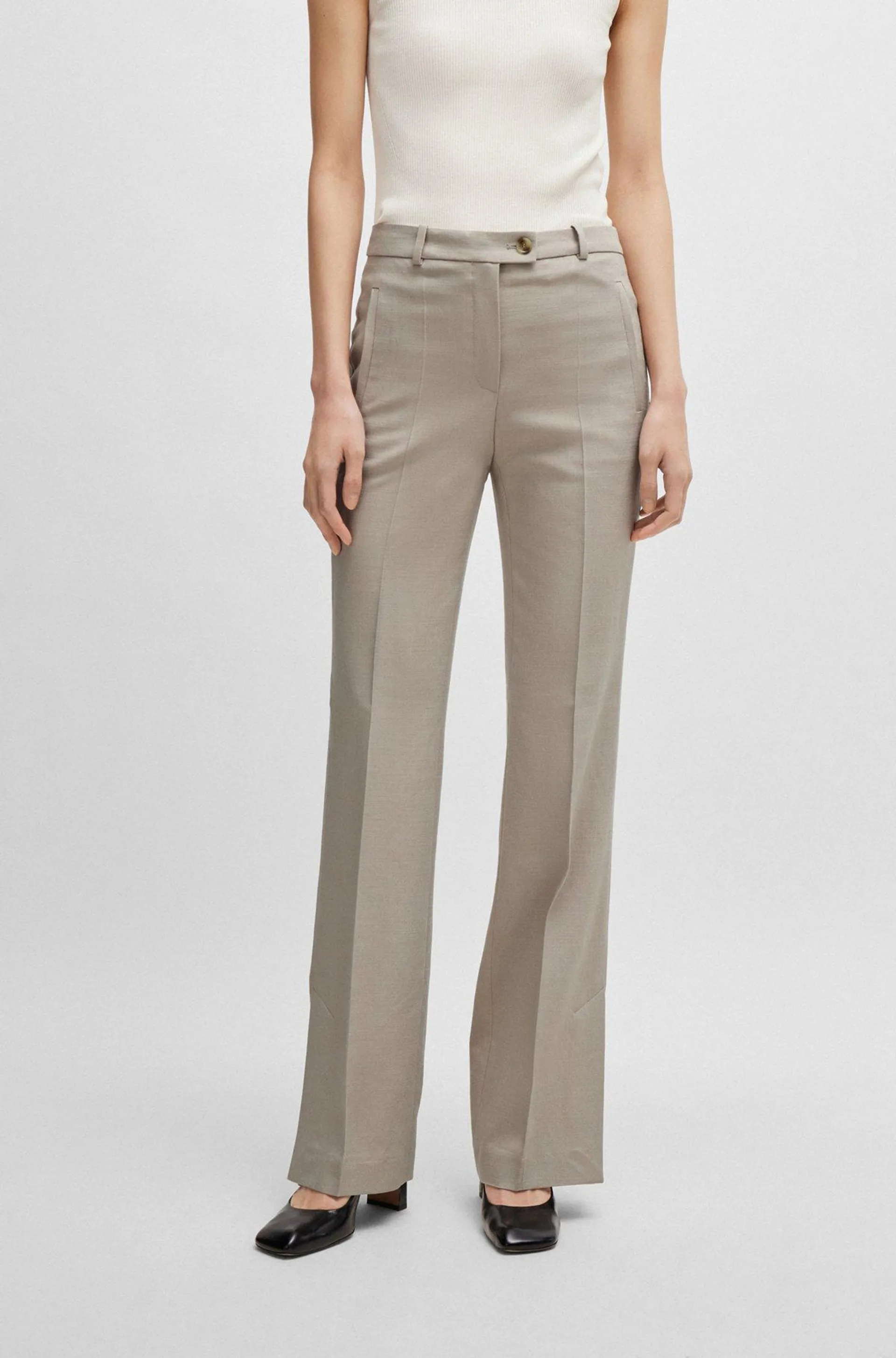 Slim-fit trousers with flared leg in stretch material