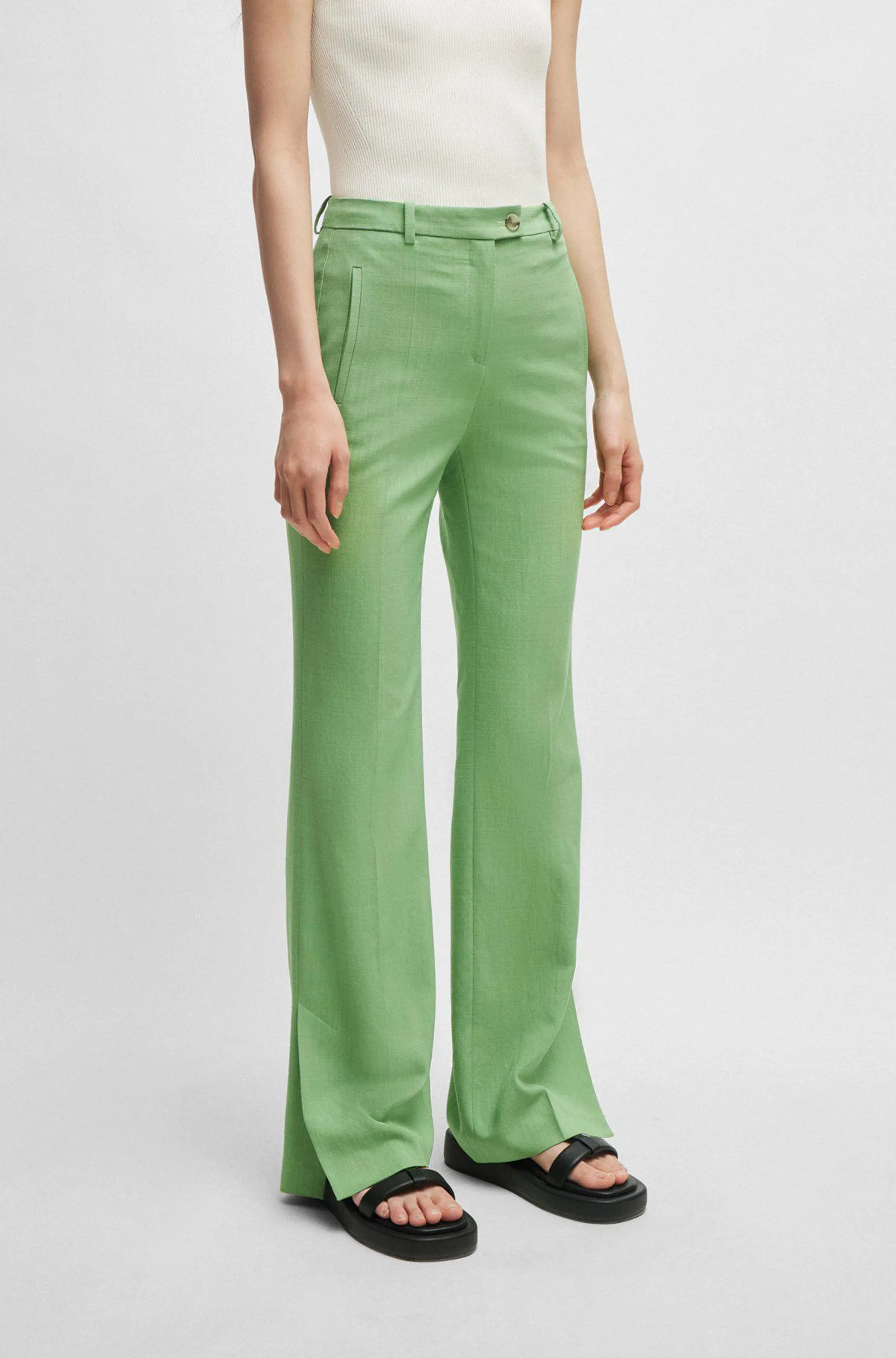 Slim-fit trousers with flared leg in stretch material