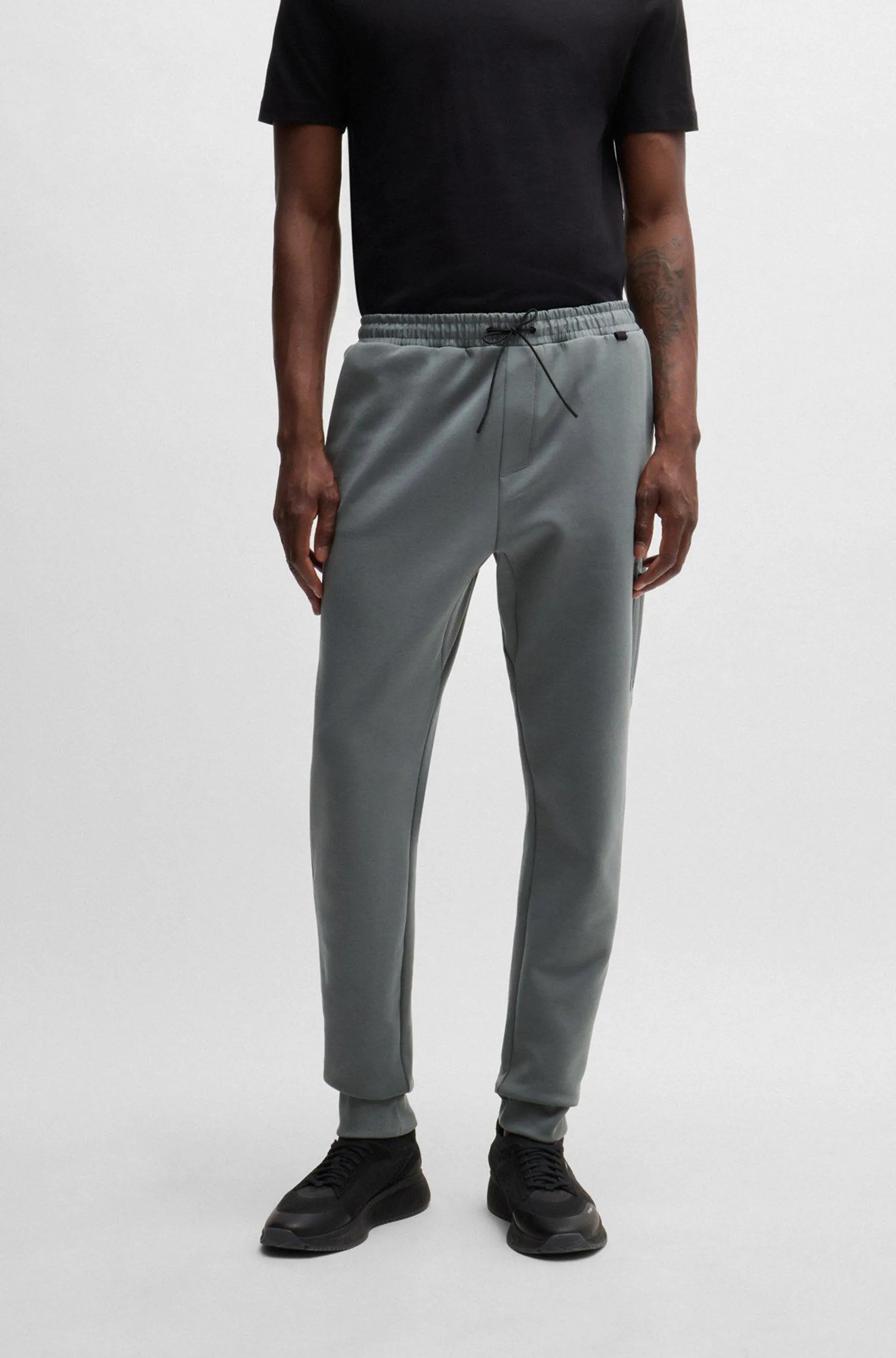 Cotton-blend tracksuit bottoms with decorative reflective logo