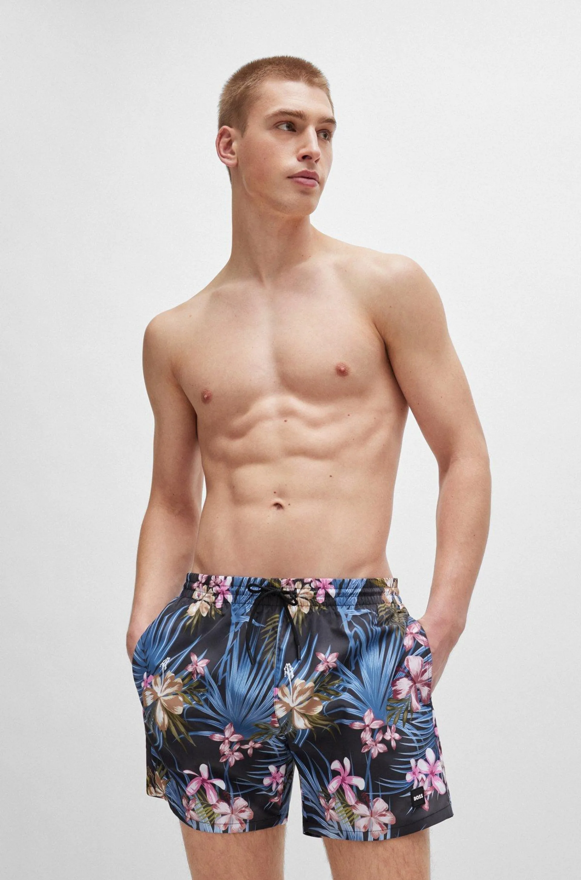 Tropical-print quick-drying swim shorts with logo badge