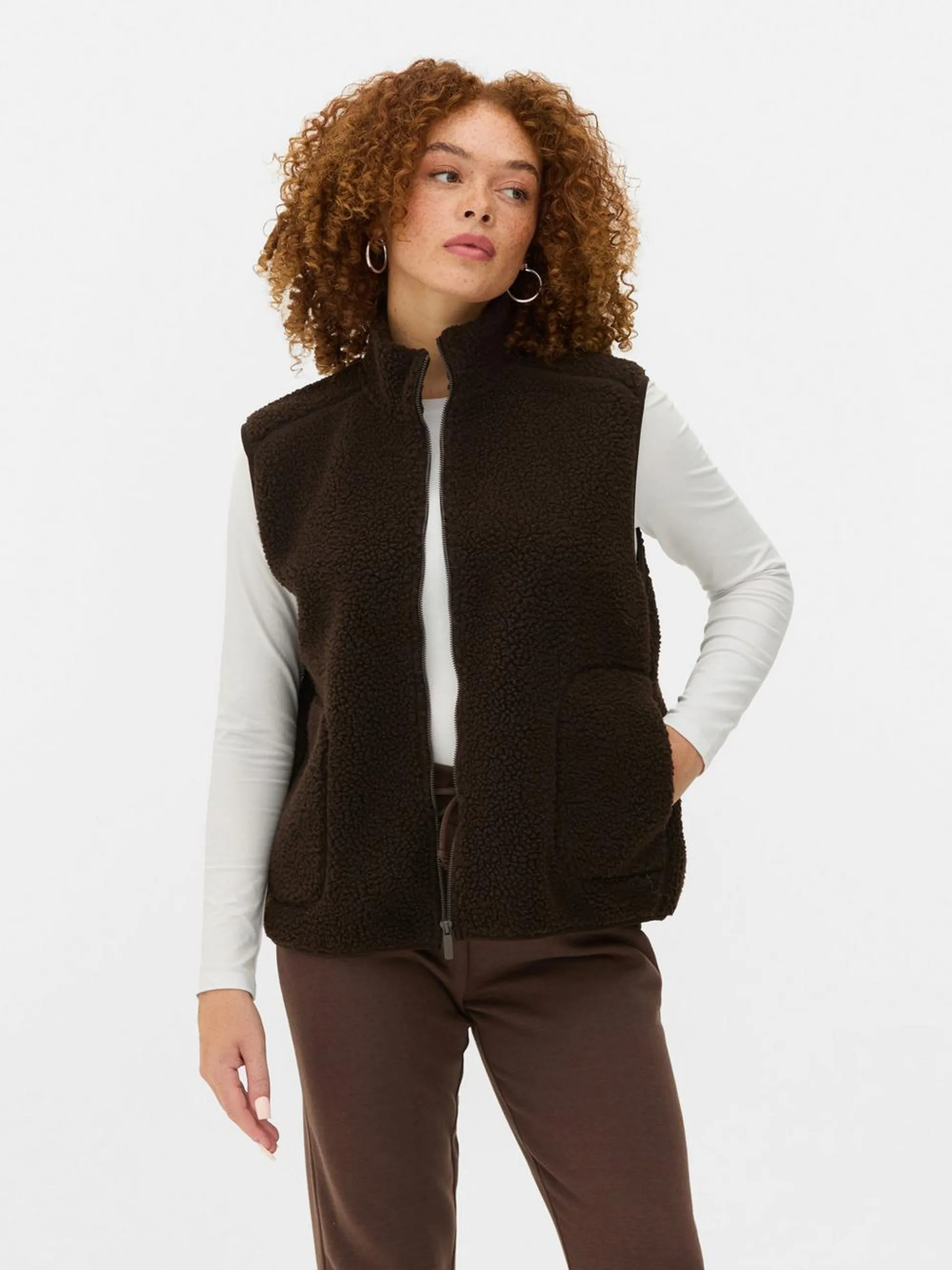 A soft sleeveless zippered vest with a chic funnel neck